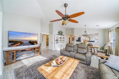 Living area with ceiling fan with notable chandeli
