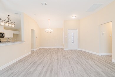 The entry opens to a formal dining room that flows