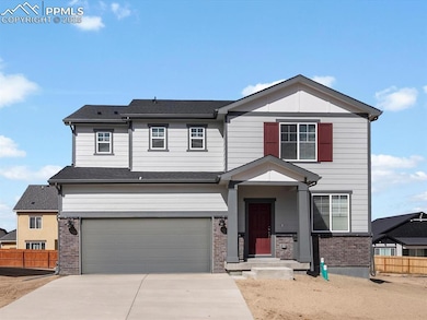 View of front of home featuring brick siding, an attached garage, concrete driveway, and a shingled roof