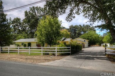 Welcoming concrete drive to oversized garage space