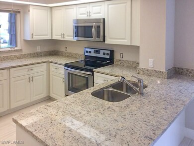 Kitchen featuring white cabinetry, sink, light sto