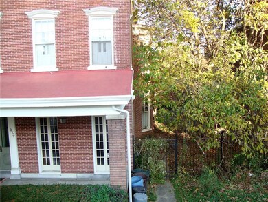 Double lot includes unit with red porch roof and l