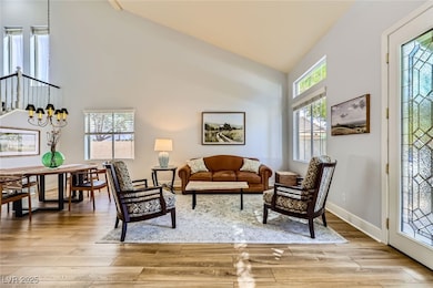 Living area featuring high vaulted ceiling, light