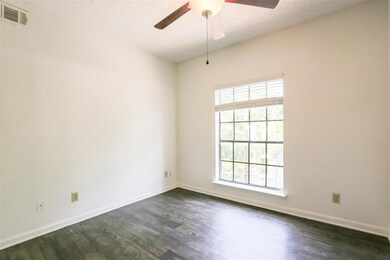 Unfurnished room with dark wood-type flooring, a 