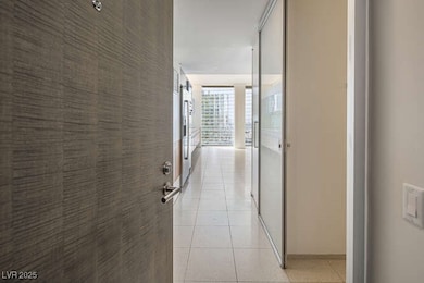 Hall with light tile patterned flooring and french