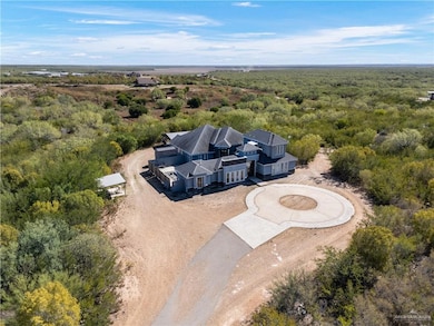 Aerial view of property and surrounding area featuring a heavily wooded area