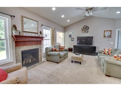 This great room offers vaulted ceilings and tile f