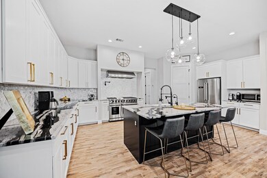 Kitchen featuring high quality appliances, a sink