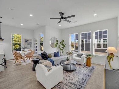 Living room with ceiling fan, light hardwood / woo