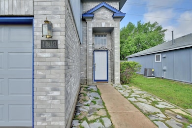 Property entrance with stone siding and a yard