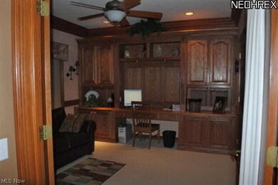 Den/Library w/custom built-in oak desk & cabinets.