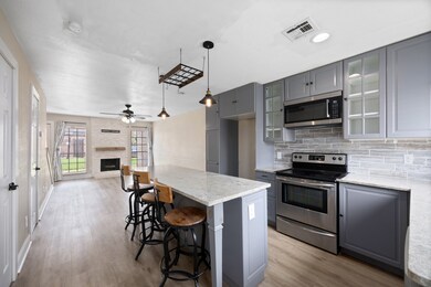 Bright Kitchen featuring stylish gray cabinetry,sl