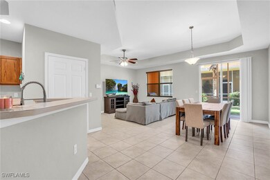Tiled dining area with a raised ceiling, sink, a w