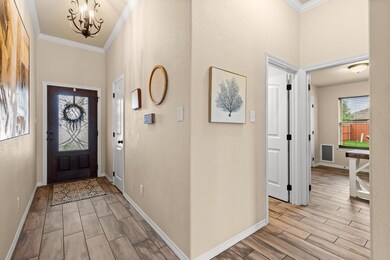 Entrance foyer with baseboards, ornamental moldin