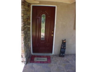 A leaded glass accented door beckons friends and family to enter.