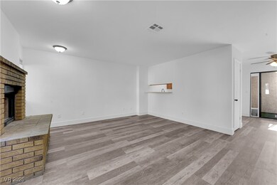 Unfurnished living room featuring a fireplace, woo