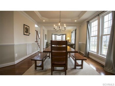 Dining and living rooms are separated by grand pil