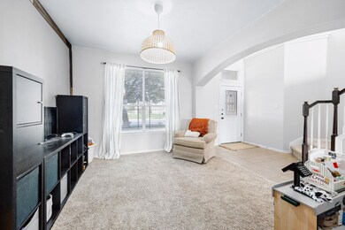 Sitting room featuring arched walkways, stairs, c