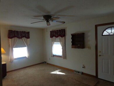 Living room has newer sandy beige wall to wall car