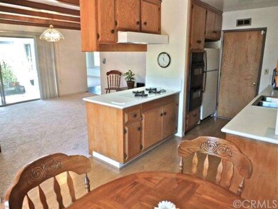 The kitchen has a gas range, double ovens and dire
