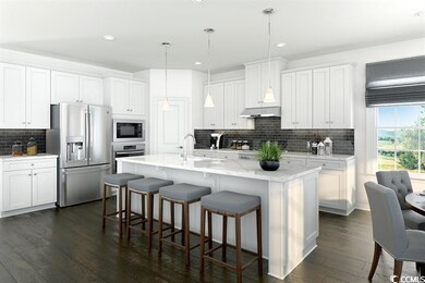 Kitchen with stainless steel appliances, white cabinets, a kitchen bar, dark wood-style floors, and recessed lighting