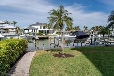 Dock area with a water view and a yard