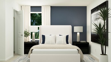 Bedroom featuring baseboards and light colored carpet