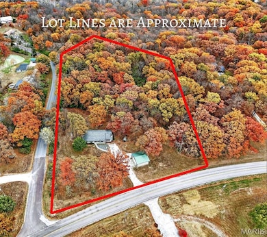 Aerial view of property and surrounding area featuring property boundaries highlighted