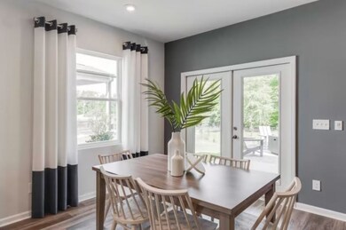 ***Photos From Previously Built Ibis Home***  Located off of the Kitchen is the Dining Room, which is designed to comfortably fit a 6-person table. The covered rear patio is located off of this space as well.