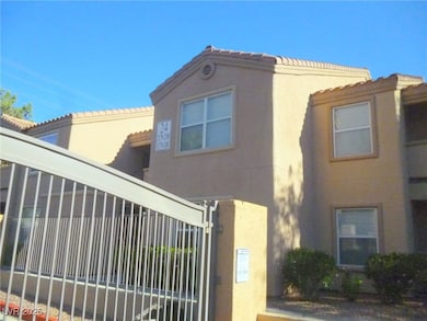 View of front of home featuring a tiled roof, a ga