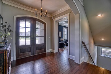 Foyer with grand mahogany doors