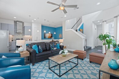 Living room featuring a ceiling fan, recessed lig