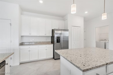 Kitchen with separate washer and dryer, stainless