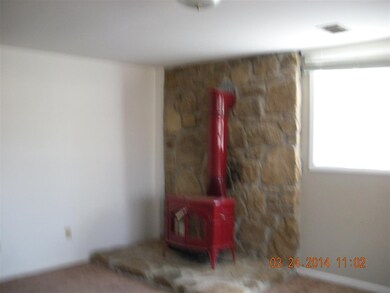 Corner woodstove in bright lower level family room