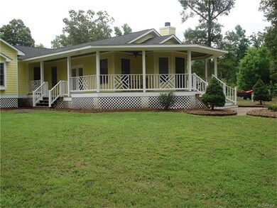 View of covered front porch with Chippendale raili