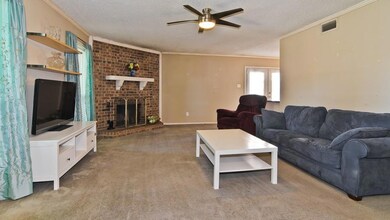 Living room featuring a brick fireplace, a texture