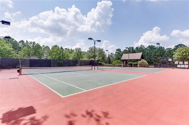 View of tennis court featuring community basketball court