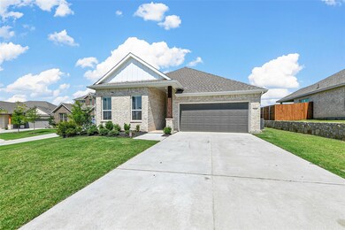 View of front of property featuring a garage and a