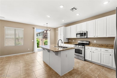 Kitchen with stainless steel appliances, dark ston
