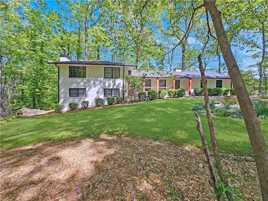Tri-level home with a chimney and a front yard