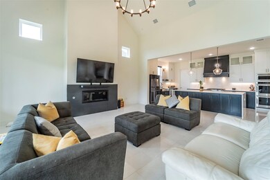 Tiled living room with an inviting chandelier and 