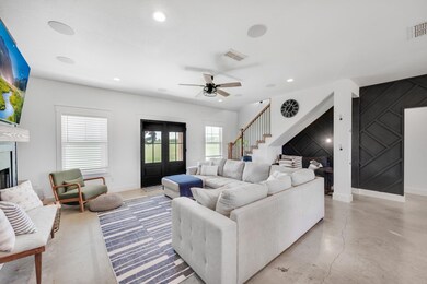Living room featuring ceiling fan and french doors