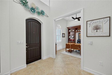 Foyer Entry, and Den with Ceiling Fan and Light Neutral Tile Diagonal Flooring