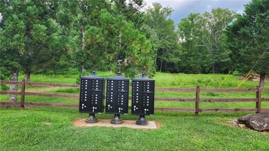 View of community with mail area and a yard