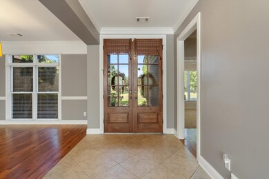 Entrance foyer with tile & gleaming hardwood floor