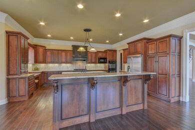This is every home chef's dream kitchen, with handsome cabinetry, dual islands, hardwood flooring, crown molding, recessed lighting, under-counter lighting, and top-of-the line appliances.