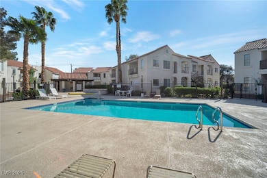 Community pool featuring a residential view, fence
