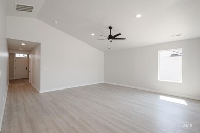 Unfurnished room with vaulted ceiling, light wood-style flooring, and recessed lighting