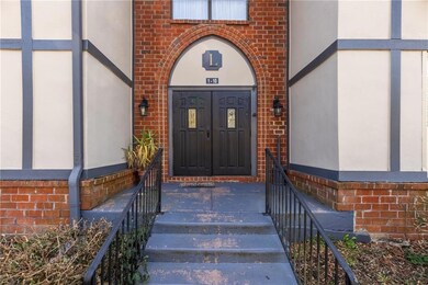 Entrance to property featuring brick siding