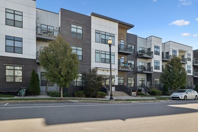 Front of building with street parking.